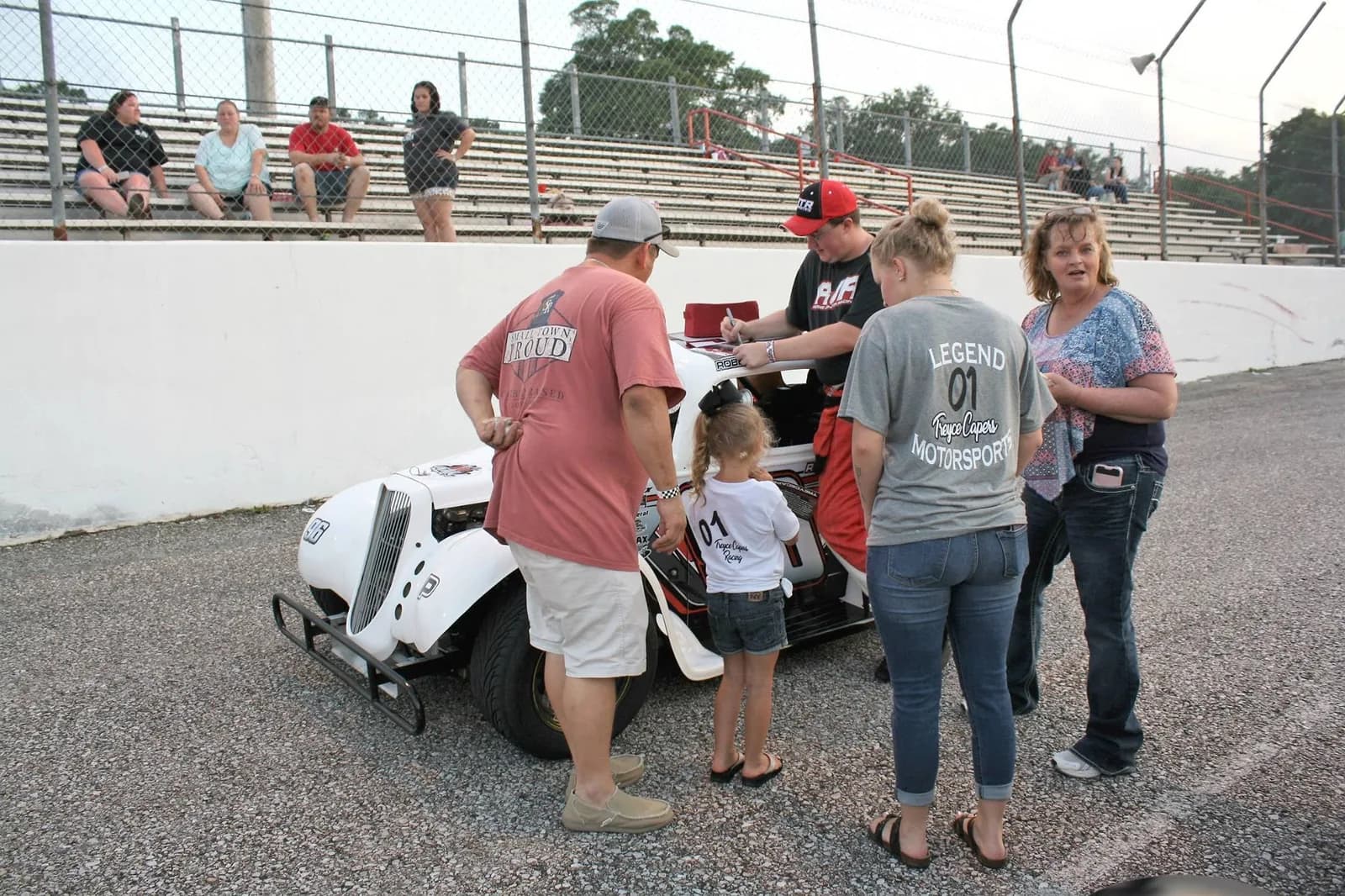 Our founder signing hero cards for fans on the frontstretch at Sunny South Raceway